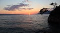 Landscape of a silhouette of a pine tree on a rock against the backdrop of a sunset, Croatia, Brela Royalty Free Stock Photo