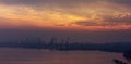 Landscape silhouettes cranes in harbor at sunset in foggy day