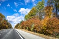 Landscape with a skyline abutting highway with picturesque autumn maple trees on the sides in New Hampshire New England Royalty Free Stock Photo