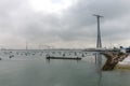 Small boats in the bay of Cadiz on a cloudy day with a huge communications tower in the background Royalty Free Stock Photo