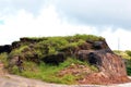 A landscape of small hillock or monticule of limestone with green grass and dark cloudy sky. Royalty Free Stock Photo