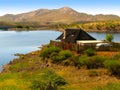 Landscape with a small house, lake, bush, camel thorn acacia trees and mountains in Central Namibia, South Africa