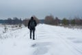 Landscape with snow covered country road and lonely wanderer in Ukraine Royalty Free Stock Photo