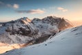 Landscape of snowy mountain on peak at sunset