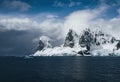 Landscape of snowy mountains and icy shores of the Lemaire Channel in the Antarctic Peninsula, Antarctica. Global Royalty Free Stock Photo