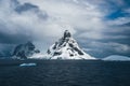 Landscape of snowy mountains and icy shores of the Lemaire Channel in the Antarctic Peninsula, Antarctica. Global Royalty Free Stock Photo