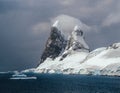 Landscape of snowy mountains and icy shores of the Lemaire Channel in the Antarctic Peninsula, Antarctica. Global Royalty Free Stock Photo