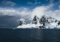 Landscape of snowy mountains and icy shores of the Lemaire Channel in the Antarctic Peninsula, Antarctica. Global Royalty Free Stock Photo