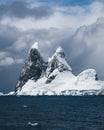 Landscape of snowy mountains and icy shores of the Lemaire Channel in the Antarctic Peninsula, Antarctica. Global Royalty Free Stock Photo