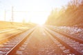 Landscape of a snowy Russian winter railway under bright sunlight The rails and sleepers under the December snow. Russian Railway