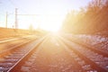 Landscape of a snowy Russian winter railway under bright sunlight The rails and sleepers under the December snow. Russian Railway