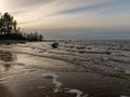 Landscape with stony beach and lonely man silhouette in the evening