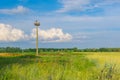 Landscape with stork hermit nest on a lonely pole against blue evening sky