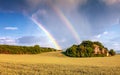 Landscape with dramatic sky and rainbow.