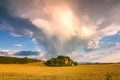 Landscape with dramatic sky and rainbow. Royalty Free Stock Photo