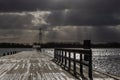 stormy clouds over a pier and dark lake Royalty Free Stock Photo