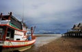 Landscape with stranded boat and vacation resort on low tide beach in Koh Lanta island province of Krabi Royalty Free Stock Photo