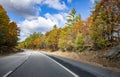 Landscape with a stretching highway road framed by autumnal scenic maples in Massachusetts Royalty Free Stock Photo