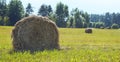 Landscape in the summer with bales of hay on the field. Panorama. Large format.