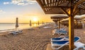 Landscape with sunbeds and umbrella