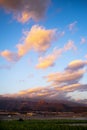 Landscape sunset beautiful view of tree bananas plantation and mountains in background with colorful amazig clouds in the blue sky