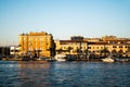 Landscape at sunset with the buildings on the other side of the city and boats Royalty Free Stock Photo