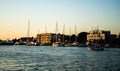 Landscape at sunset with the buildings on the other side of the city and boats Royalty Free Stock Photo