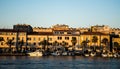 Landscape at sunset with the buildings on the other side of the city and boats Royalty Free Stock Photo