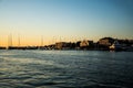 Landscape at sunset with the buildings on the other side of the city and boats Royalty Free Stock Photo