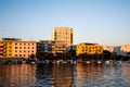 Landscape at sunset with the buildings on the other side of the city and boats Royalty Free Stock Photo