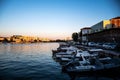 Landscape at sunset with the buildings on the other side of the city and boats Royalty Free Stock Photo