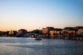 Landscape at sunset with the buildings on the other side of the city and boats Royalty Free Stock Photo