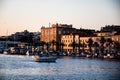 Landscape at sunset with the buildings on the other side of the city and boats Royalty Free Stock Photo