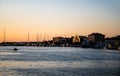 Landscape at sunset with the buildings on the other side of the city and boats Royalty Free Stock Photo