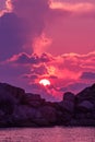 Landscape of sunset with dramatic sky on background with rock island and sea. Royalty Free Stock Photo