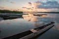 Landscape with sunset with fishing canoes on the river edge