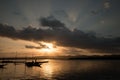 Landscape with sunset with fishing canoes on the river edge