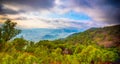 Landscape of sunset on Green mountains and beautiful sky clouds under the blue sky, Dramatic moving cloud in nature landscape. -