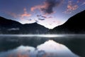 Landscape with sunset lake reflections in autumn, location Alps, Italy, Europe colorful autumn trees reflecting in lake. Royalty Free Stock Photo