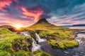 Landscape of sunset over Kirkjufell mountain with Kirkjufellsfoss waterfall and colorful pileus cloud on summer at Iceland Royalty Free Stock Photo