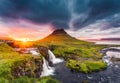 Landscape of sunset over Kirkjufell mountain with Kirkjufellsfoss waterfall and colorful pileus cloud on summer at Iceland Royalty Free Stock Photo