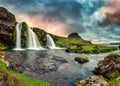 Landscape of sunset over Kirkjufell mountain with Kirkjufellsfoss waterfall and colorful pileus cloud on summer at Iceland Royalty Free Stock Photo