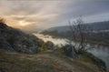 Landscape of sunset over the Southern Bug river. The morning sun makes its way through the fluffy clouds and fog Royalty Free Stock Photo