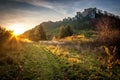 Landscape at sunset with ruin of medieval castle. Royalty Free Stock Photo