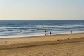 Landscape Surfers Paradise beach with two people entering surf with surfboards