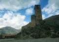 Landscape, with Svan guard tower on a background of snow-capped mountain peaks and clouds, Svaneti Royalty Free Stock Photo