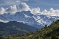 Landscape, with Svan watchtowers and agricultural fields on the background of snow-capped mountain peaks and clouds, Svaneti Royalty Free Stock Photo