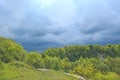 Landscape with thundercloud over green forest. Stormcloud above green vegetation