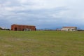 Landscape with a tobacco dryer under cloudy sky