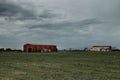 Landscape with a tobacco dryer under cloudy sky